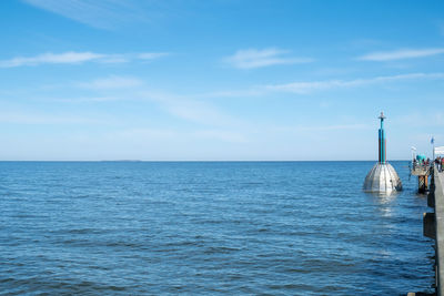 Scenic view of sea against blue sky