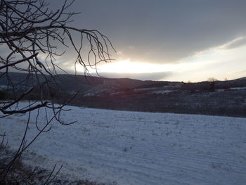 Scenic view of snowcapped mountains against sky during sunset