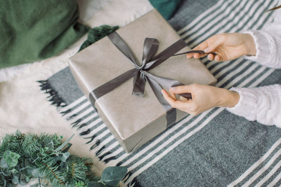 Cropped hand of woman holding gift box