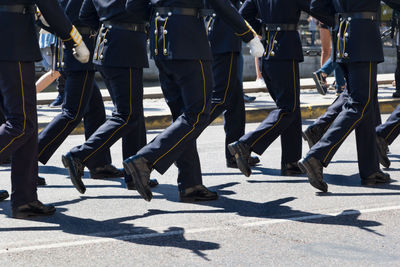 Low section of people walking on street