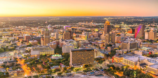 High angle view of illuminated cityscape against sky during sunset