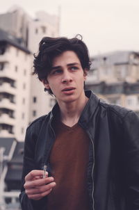 Portrait of young man standing outdoors