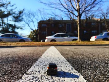 Cars on road against sky in city