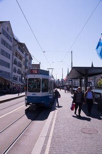 People on city street against sky