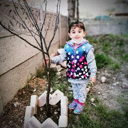 Portrait of cute girl standing outdoors