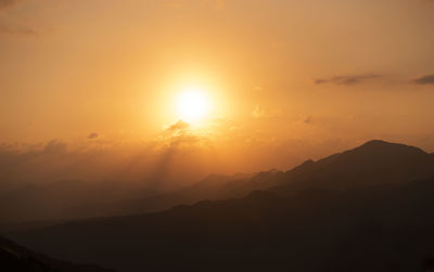 Scenic view of silhouette mountains against sky during sunset