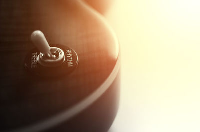 Close-up of hand holding cup over white background