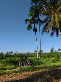 Bicycle on field against sky