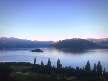 Scenic view of lake against clear blue sky