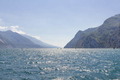 Scenic view of sea and mountains against sky