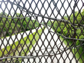 Close-up of chainlink fence against sky