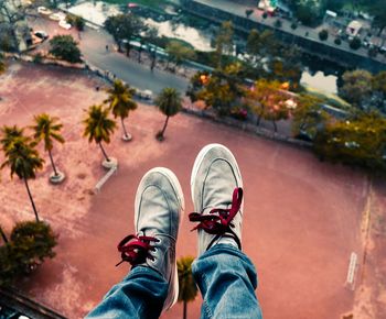 Low section of man sitting on rooftop