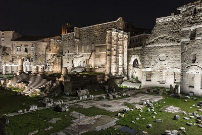 Old buildings in city at night