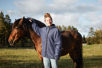 Portrait of horse standing on field