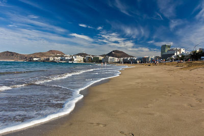 Panoramic view of beach against cloudy sky