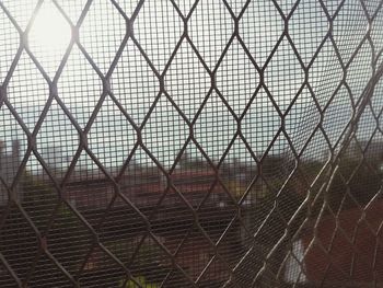 Close-up of chainlink fence against sky