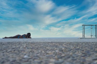 Surface level of pebbles on beach against sky