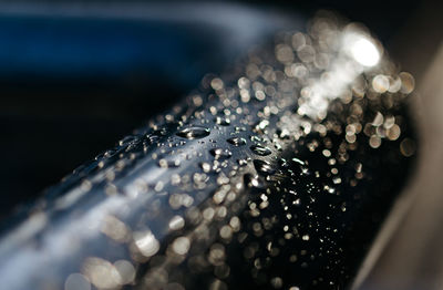 Close-up of water drops on the metallic surface 