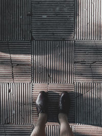 Low section of woman standing on tiled floor