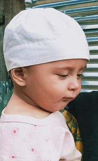 Close-up portrait of cute boy looking away