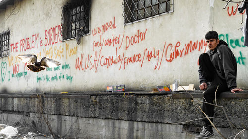 Man and graffiti on wall