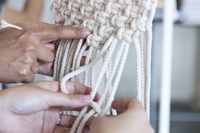 Cropped hands knitting ropes