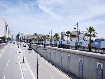 Panoramic view of city street and buildings against sky