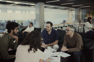 Group of business people having meeting in lobby