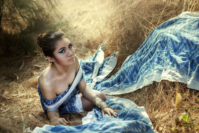 Portrait of young woman sitting outdoors