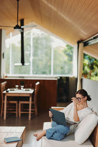 Young woman sitting on table