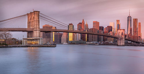 Bridge over river with city in background