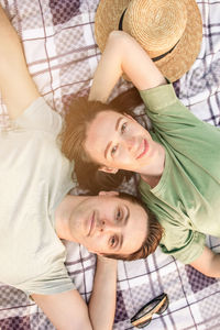 Portrait of couple lying outdoors