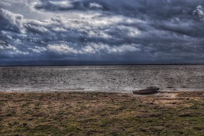 Scenic view of sea against cloudy sky