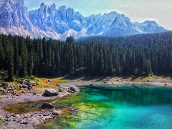 Scenic view of lake by mountains against sky