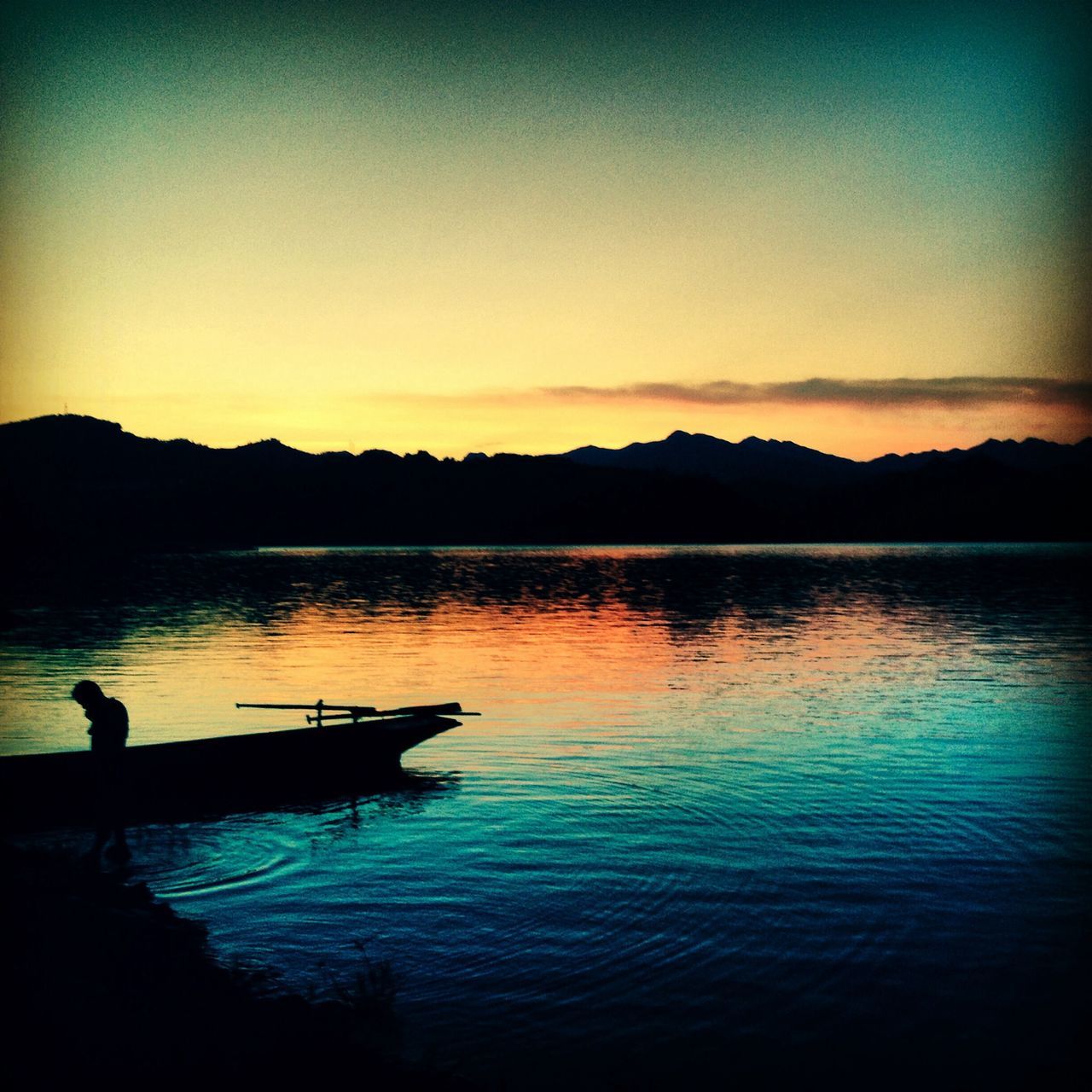 sunset, water, silhouette, tranquil scene, tranquility, lake, scenics, reflection, beauty in nature, nature, mountain, idyllic, nautical vessel, sky, waterfront, orange color, copy space, calm, dusk, boat