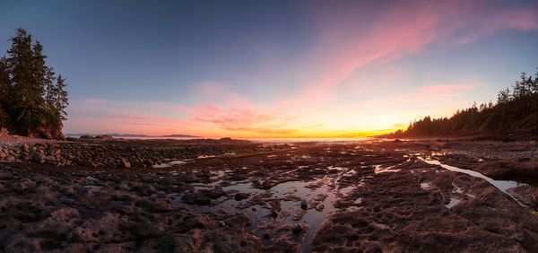 Scenic view of land against sky during sunset