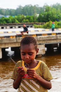 Portrait of boy holding water