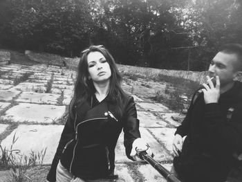 Portrait of friends standing against trees
