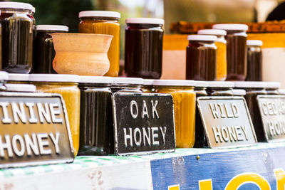 Information sign by honey jars in market