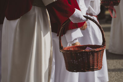 Midsection of man standing in basket