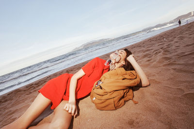 Portrait of woman sitting at beach