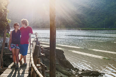 Young couple hiking on boardwalk in vietnam's halong bay