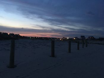 Scenic view of beach against sky at sunset