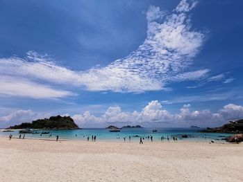 Scenic view of beach against blue sky