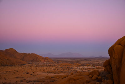 Scenic view of desert against sky during sunset