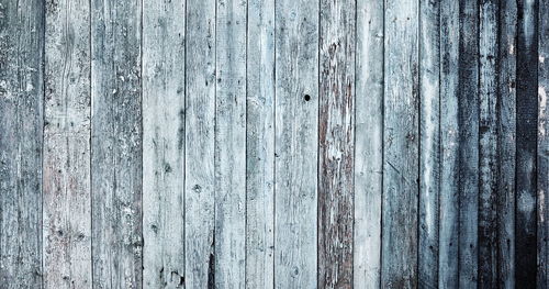 Wooden natural of old wooden house wall cladding with blue and blue peeling paint.