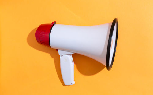 High angle view of umbrella against orange background