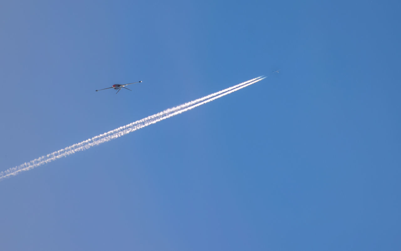 LOW ANGLE VIEW OF AIRPLANE FLYING IN SKY