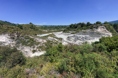 Scenic view of land against clear blue sky