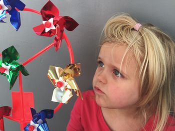 High angle view of girl looking at pinwheel